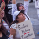 People demonstrate and call out words of encouragement to detainees held inside the Metropolitan Detention Center after marching to decry Trump administration immigration and refugee policies on June 30, 2018 in Los Angeles, California.